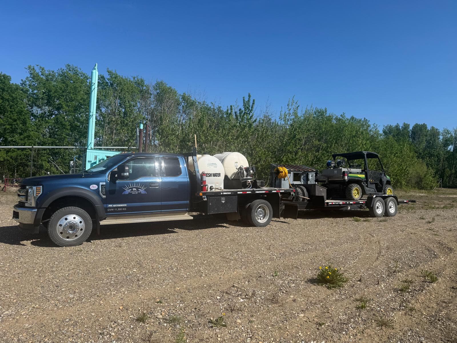 Vegetation management spray truck and trailer set up on an industrial right-of-way